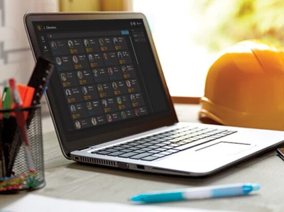 Laptop on a work desk with the screen showing the weavix global directory