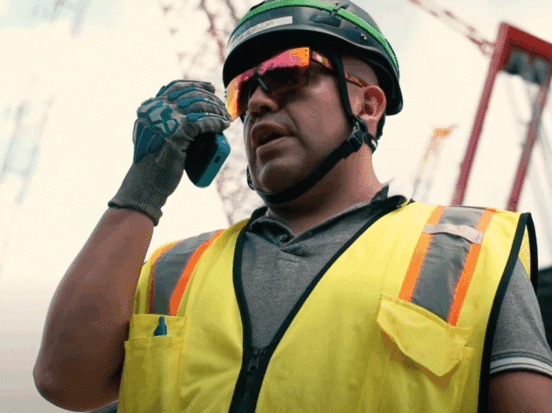 Construction worker using a Walt Smart Radio for communication