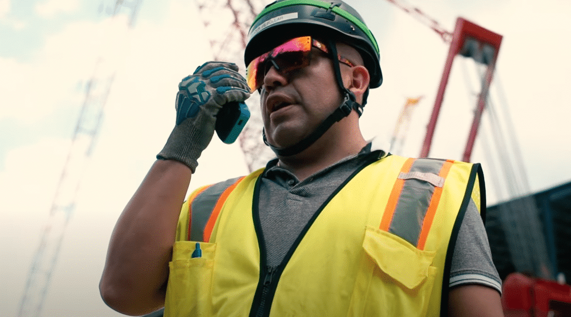 Construction worker using a Walt Smart Radio for communication