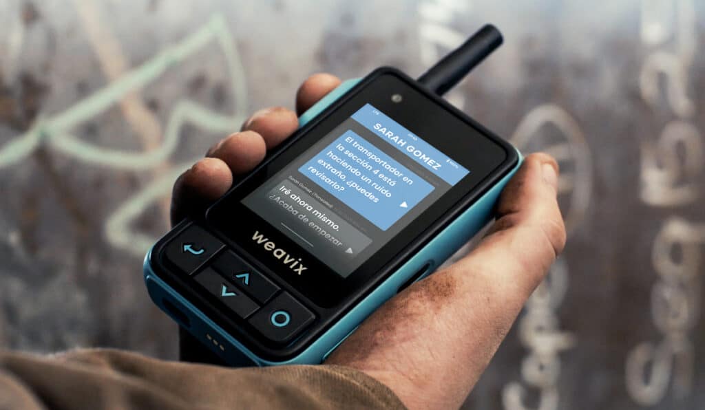 A close-up of a Walt Smart Radio with a screen displaying its language translation capabilities for Spanish