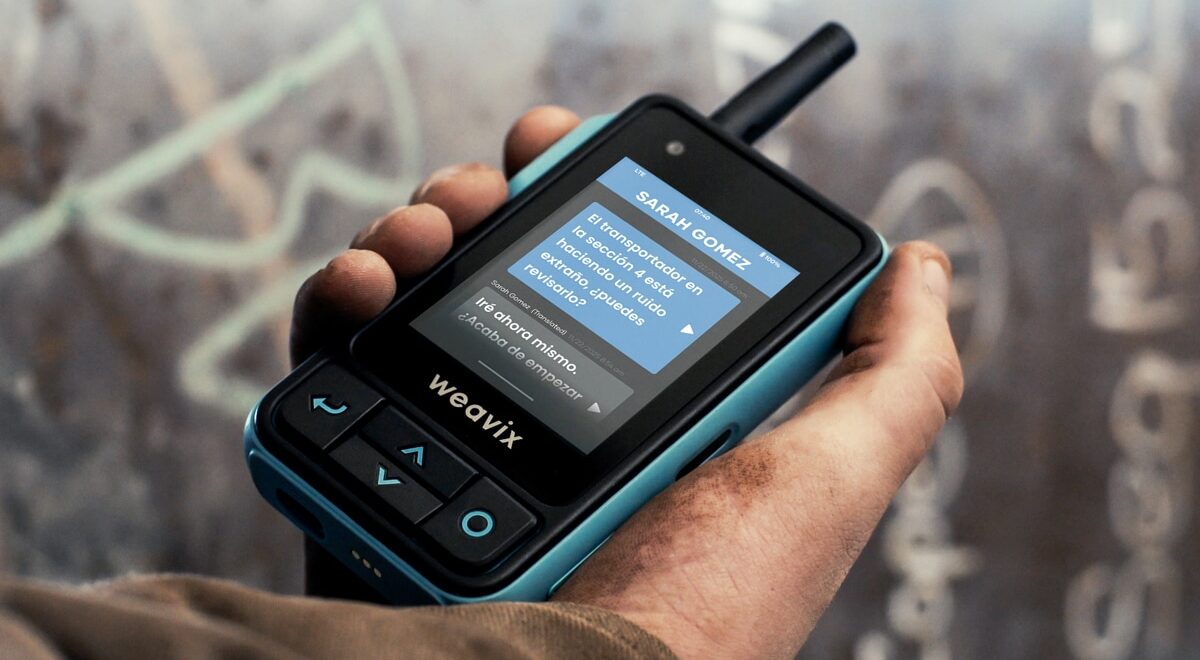 A close-up of a Walt Smart Radio with a screen displaying its language translation capabilities for Spanish