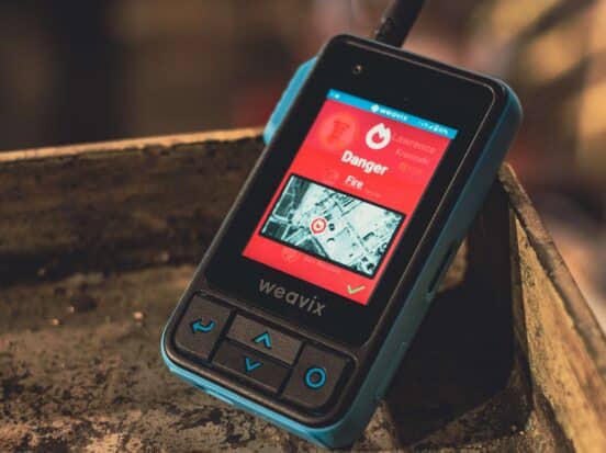 Thumbnail for a blog post on five ways a mass notification system improves worker safety, showing a Walt Smart Radio displaying an alert for danger from fire.