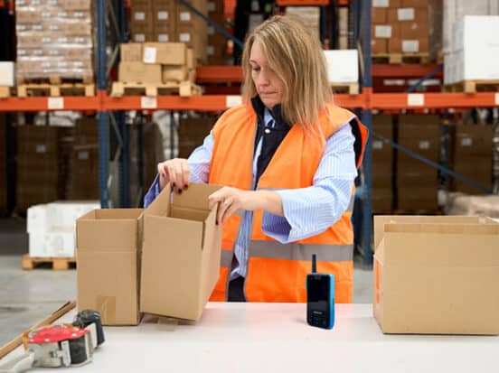 Warehouse worker sorting out boxes