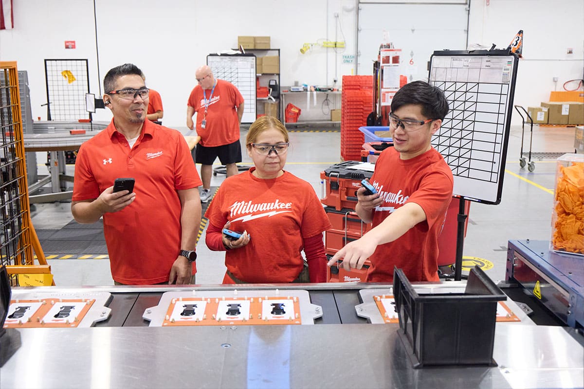 Milwaukee Tool frontline workers collaborating using the Walt Smart Radio