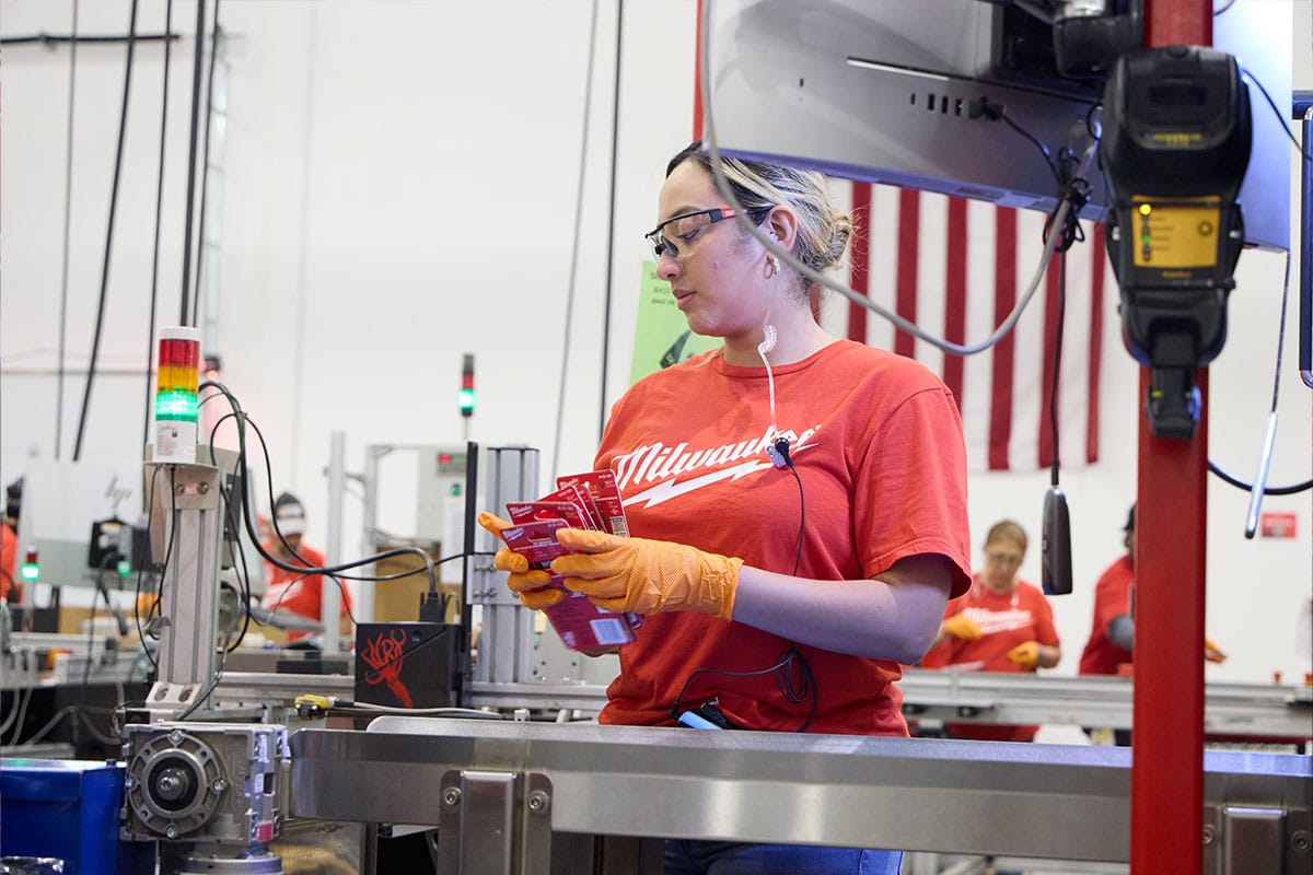 Milwaukee tool worker sorting out packages in a warehouse