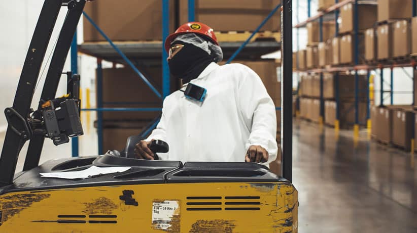 Warehouse worker operating a forklift