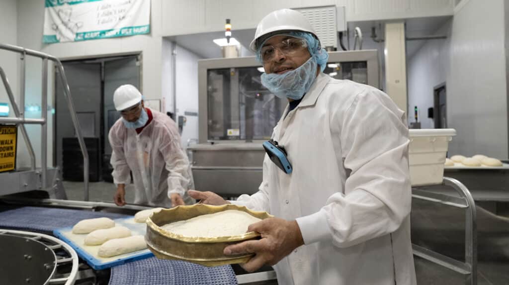 Aspire Bakeries worker with a Walt Smart Radio