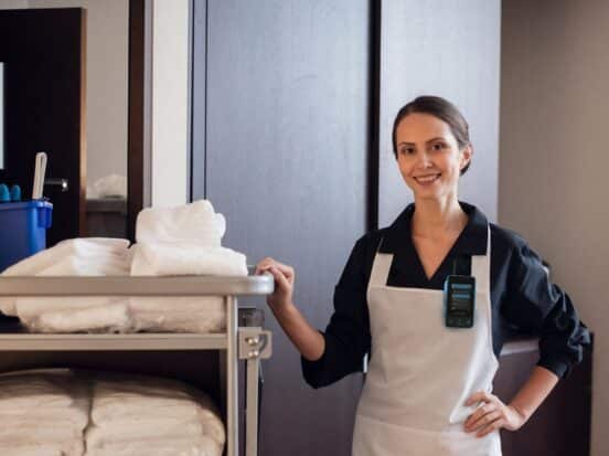 Housekeeping staff member with a Walt Smart Radio by weavix