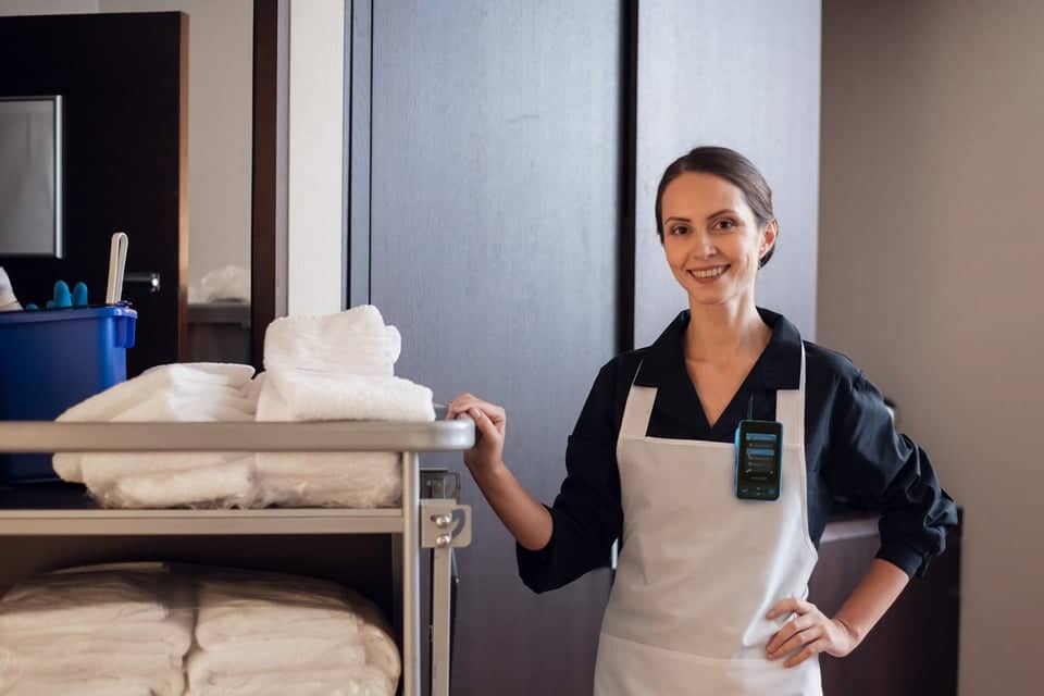 Housekeeping staff member with a Walt Smart Radio by weavix