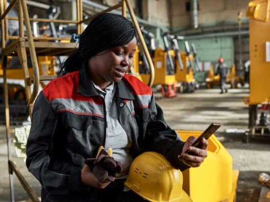 Industrial worker using a smartphone at work