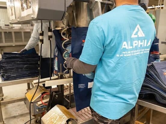 Alphia plant worker holding a packaging box