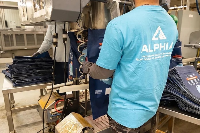Alphia plant worker holding a packaging box